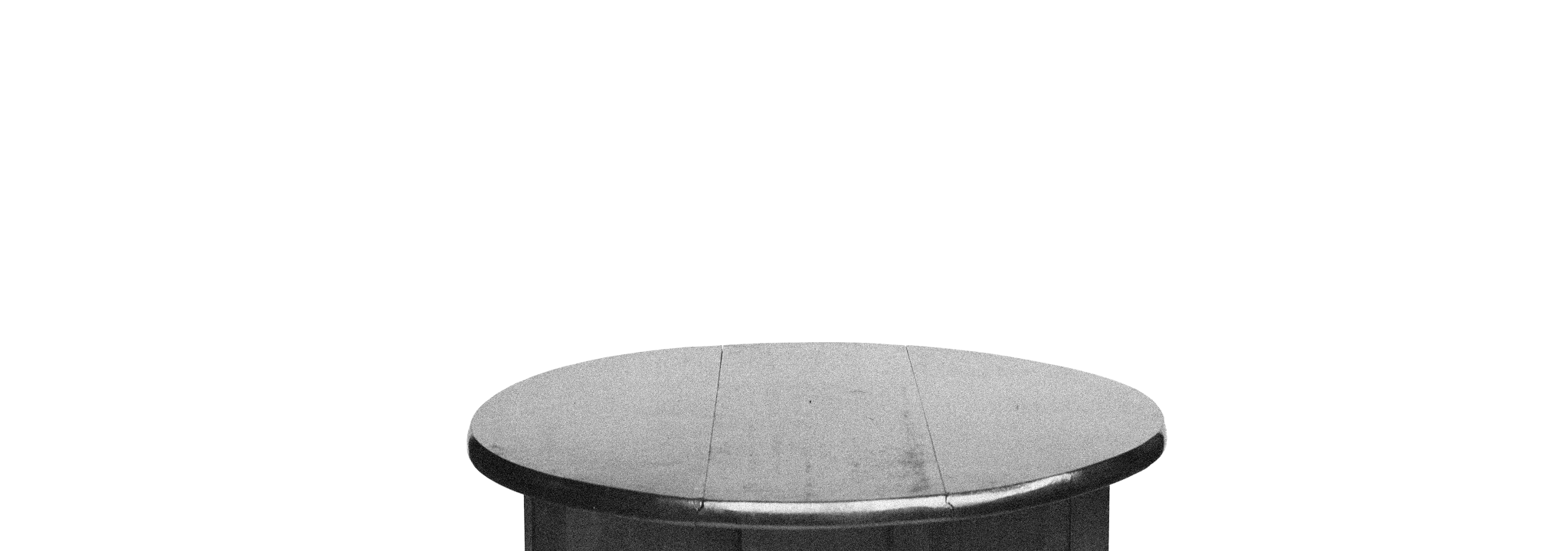 A black and white photo of an oval dining table